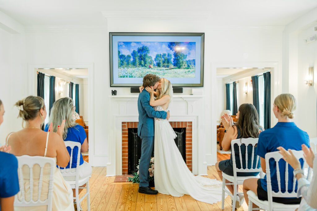 a couple shares a kiss on the day of their eastern shore wedding at queenstown harbor