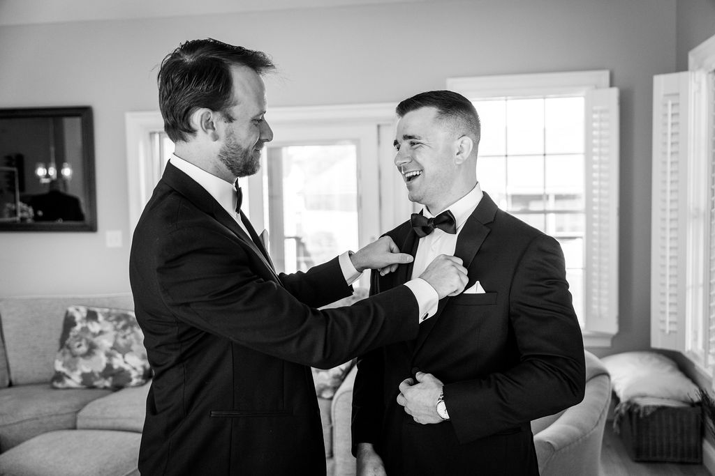 the groom gets his tuxedo adjusted