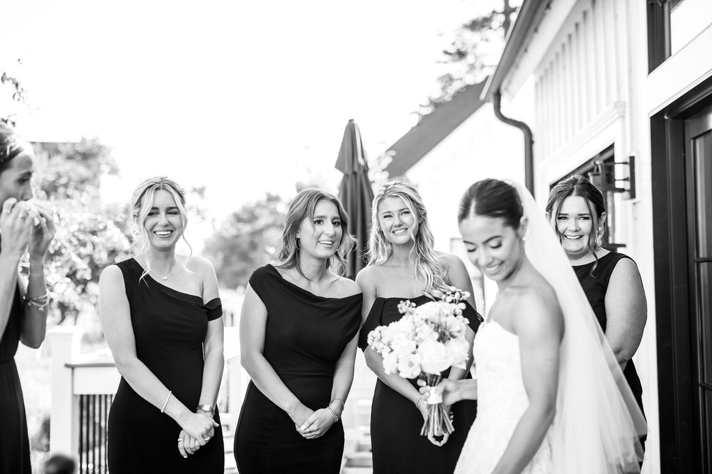 the bride stands with her bridesmaids at queenstown harbor