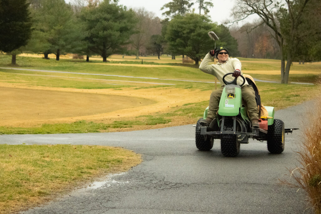 a groundskeeper smiles for a photo at queenstown harbor golf resort