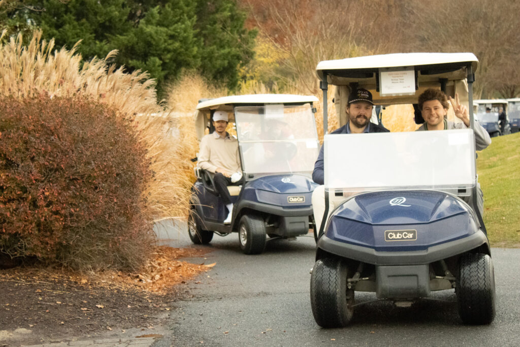 a couple of golf carts drive by on thanksgiving at queenstown harbor