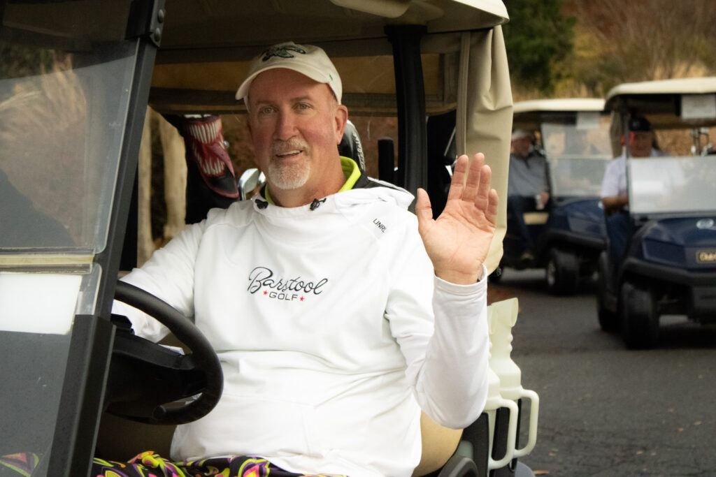 a man waves hello on thanksgiving during the annual Queenstown Harbor Cross Country Tournament