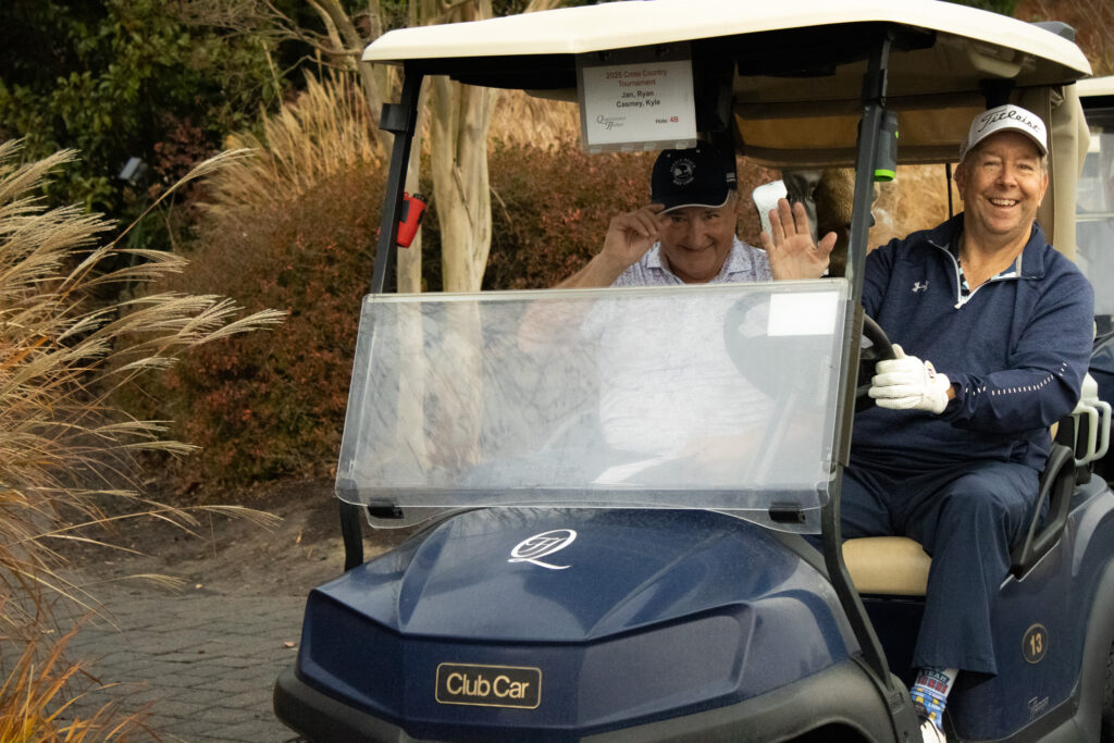two men are very happy to be participating in the annual Queenstown Harbor Cross Country Tournament