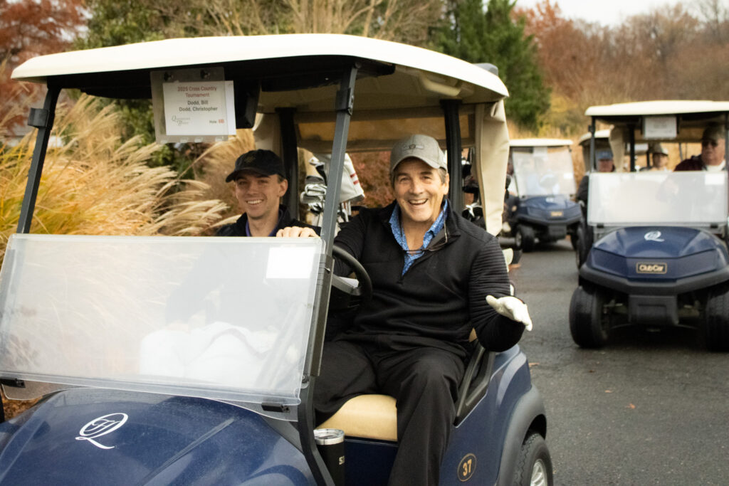 a slew of golf carts are driving by at queenstown harbor golf resort