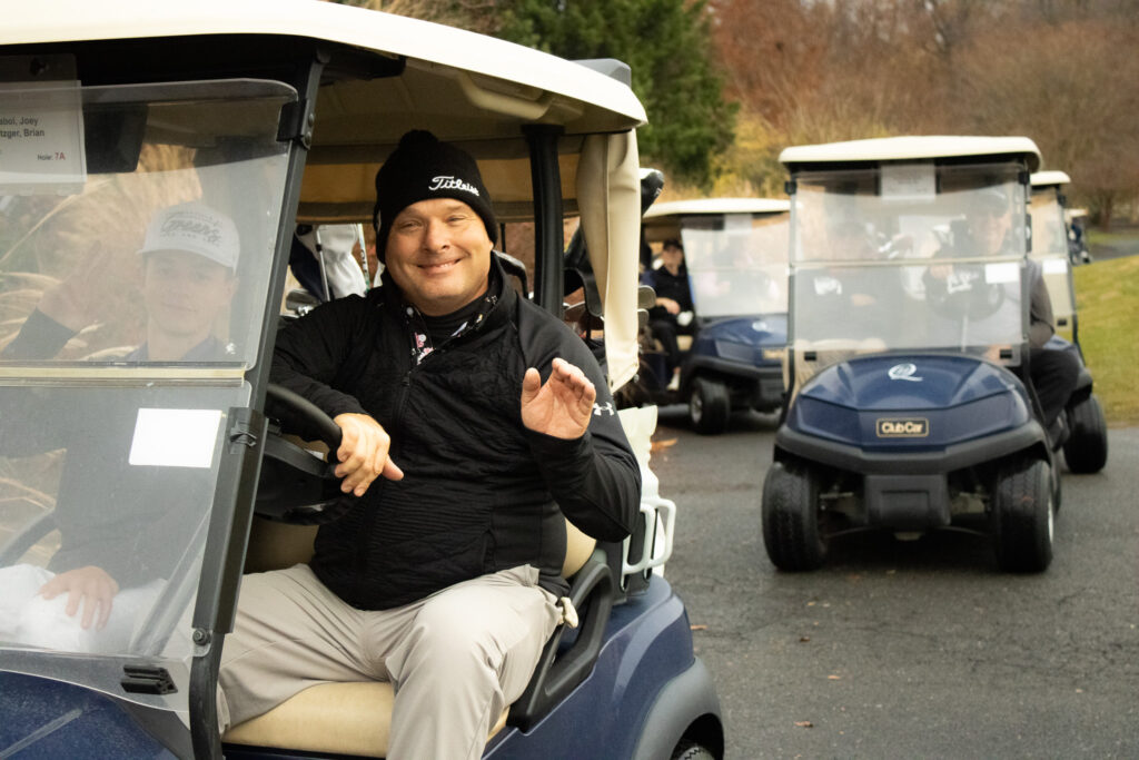 a participant of the annual Queenstown Harbor Cross Country Tournament waves to the camera