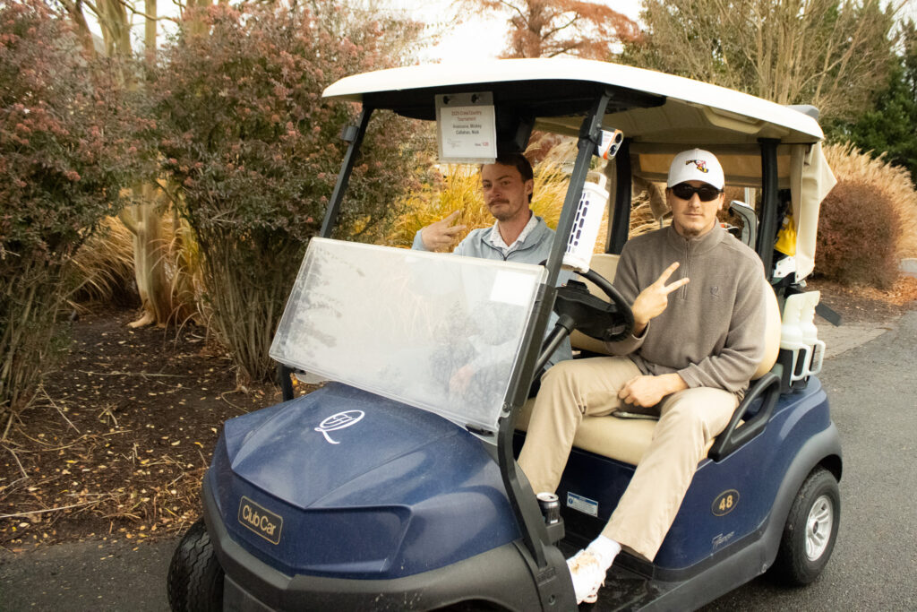 two golfers hold up 'peace signs' as they get ready for the annual Queenstown Harbor Cross Country Tournament