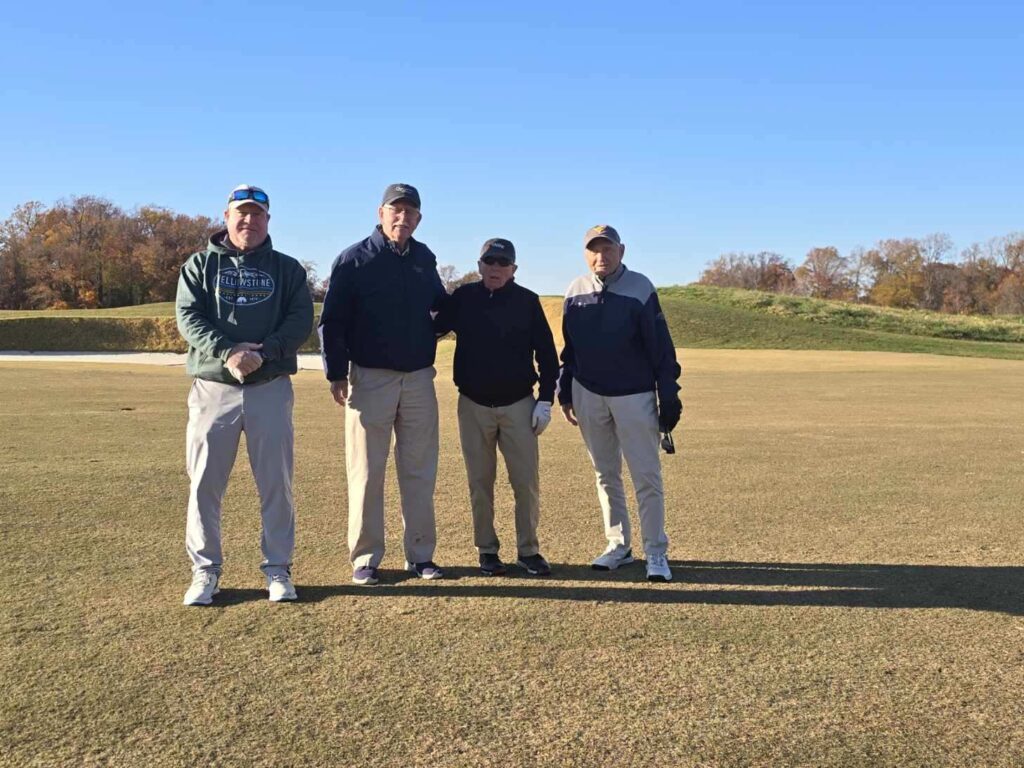 golfers pose together at queenstown harbor golf resort